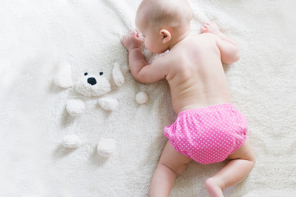 baby crawling on bed