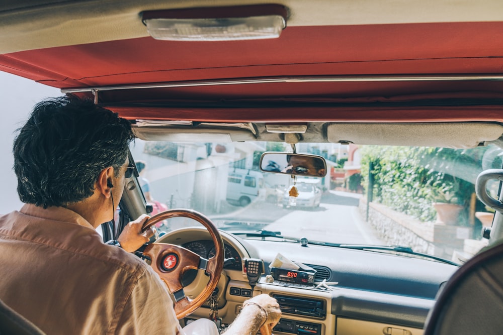 man driving a car during daytime