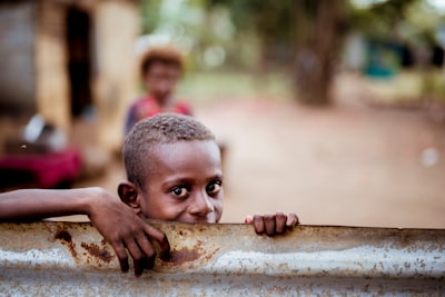 boy holding corrugated sheet hungry teams background