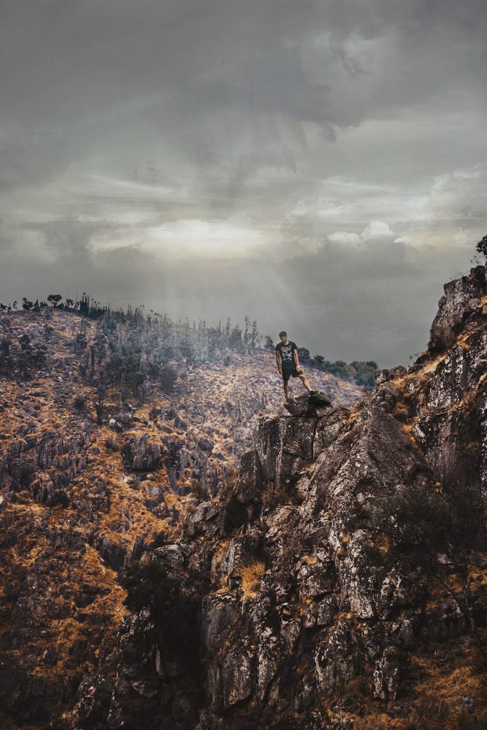 man on cliff mountain