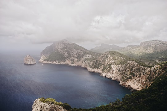 mountains surrounded by body of water under cloudy sky during daytime in Majorca Spain