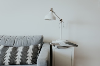 white desk lamp near gray fabric couch