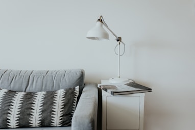 white desk lamp near gray fabric couch