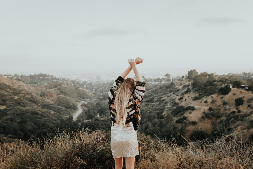 woman standing on top of mountain