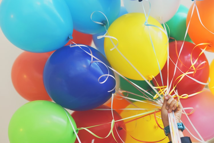 colourful balloons and ribbon to say well done