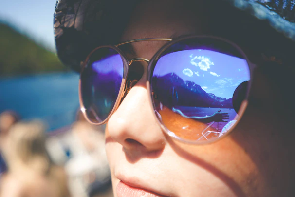 A vibrant display of sporty sunglasses with a mountain trail in the background.