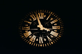 A golden clock on a navy blue wall symbolizing efficient time management in HR.