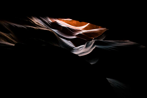 A mysterious glowing crystal formation emerging from ancient rock layers at twilight.