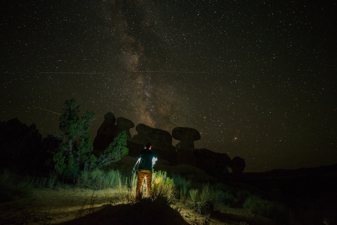 person standing near rock formation during night time