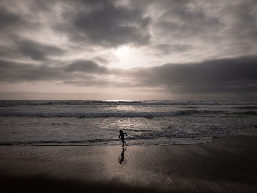 silhouette of person near beach