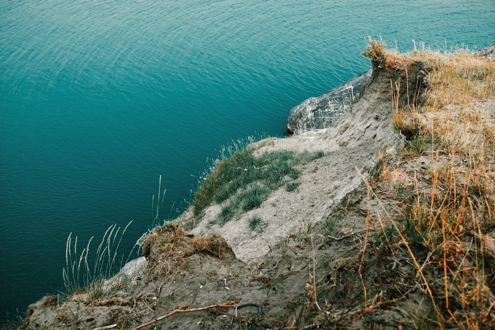 cliff beside body of water