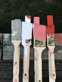 Close-up of paint rollers and brushes ready for a building painting project.