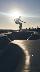 Close-up of a skateboarder performing a trick on a sunny day.