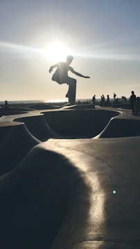 Close-up of a skateboarder performing a trick on a sunny day.