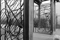 A panoramic shot of an outdoor architectural metalwork installation integrated into a public park.