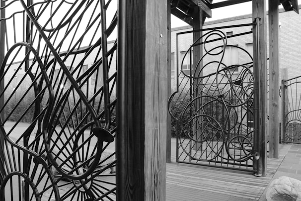 Artisan carefully assembling a large metal art installation outdoors