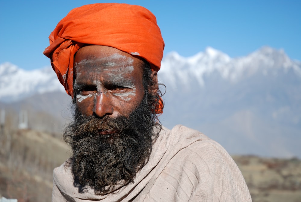 man wearing orange turban and gray top