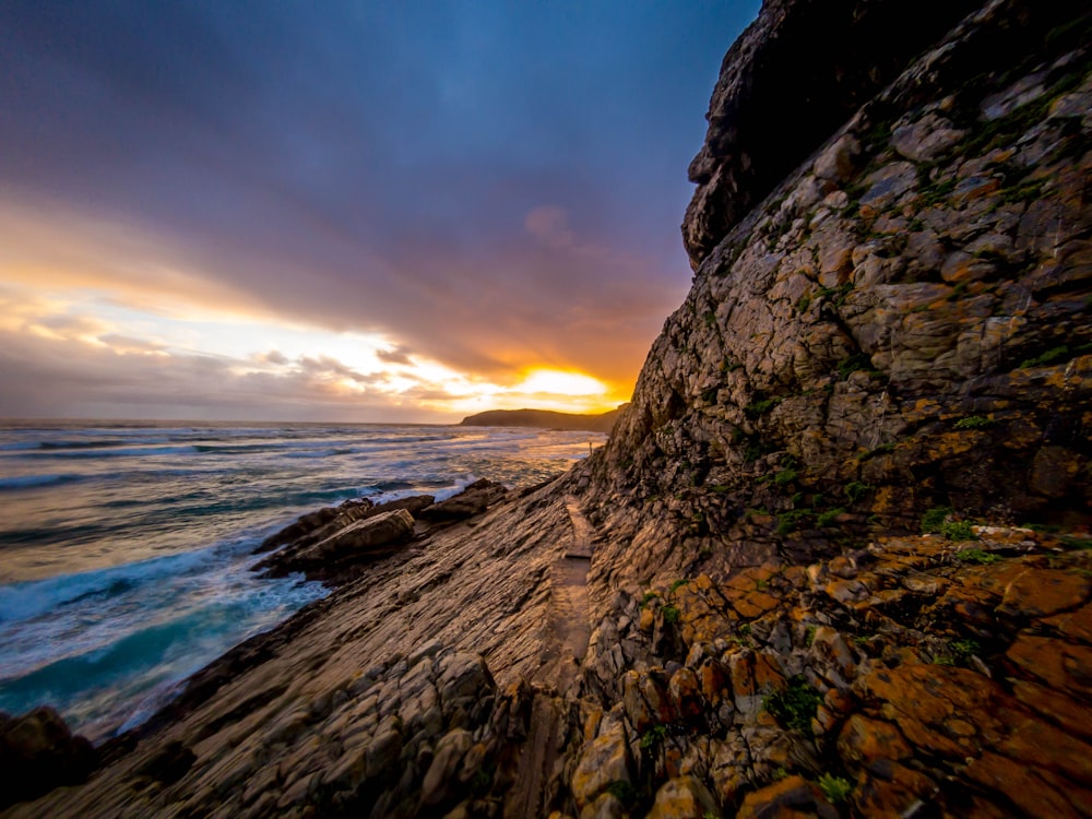 brown rock formation near seashore