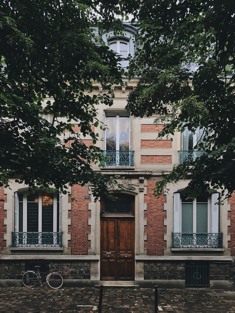 white and brown concrete building near trees at daytime