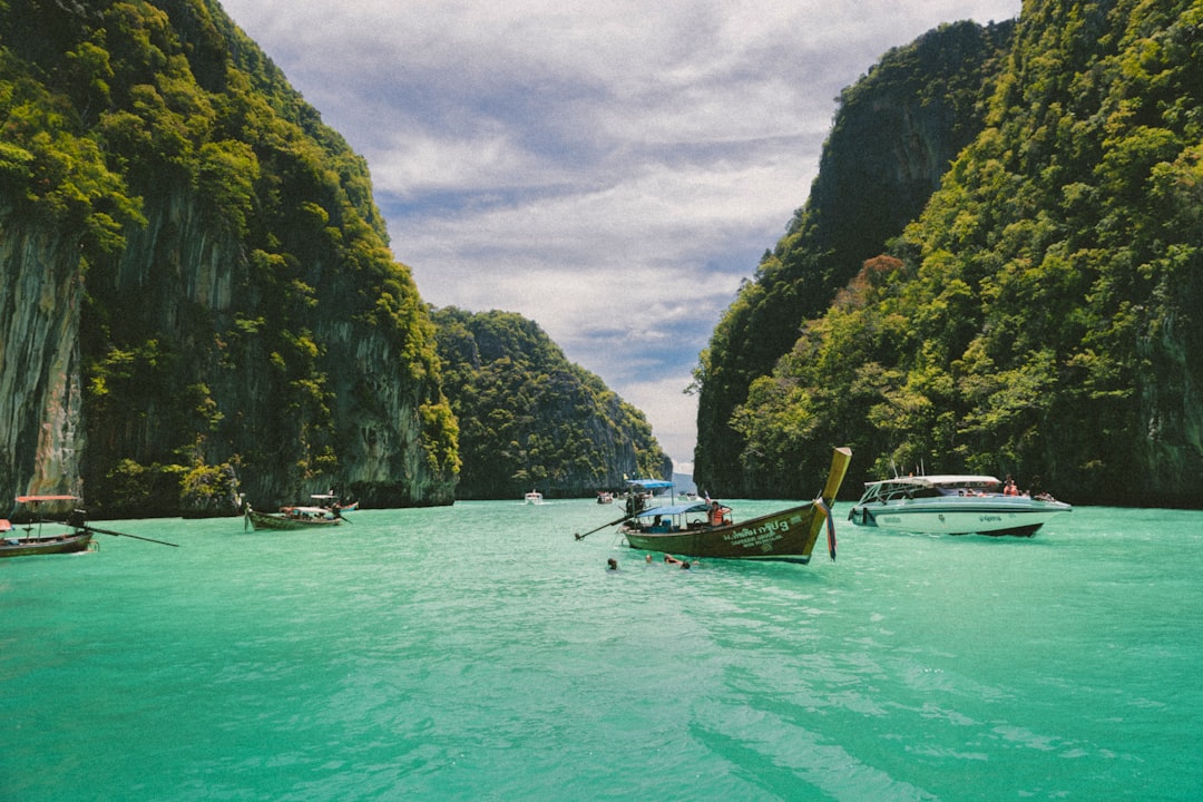 four wooden boat on teal sea