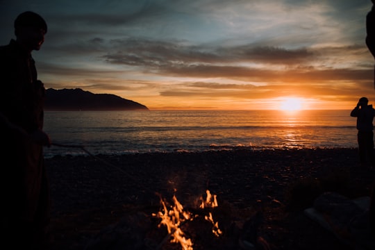 silhouette of person standing near bonfire in Kaikoura New Zealand
