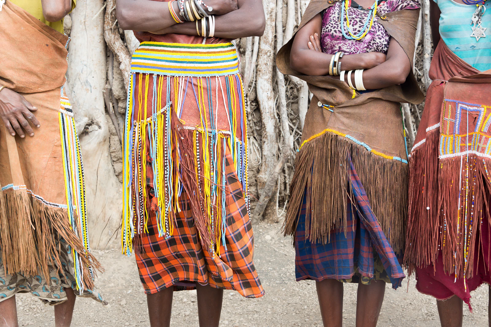 Four people wearing fringed clothes