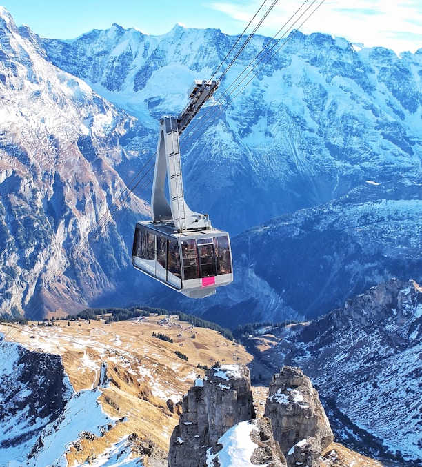 bird's eye view of ski lift over mountains during winter