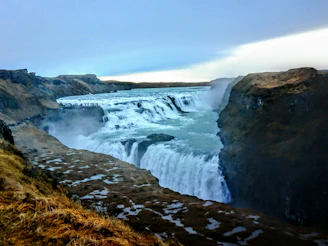 Wide shot of the 7-meter waterfall cascading into the canyon below