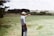 man wearing gray long-sleeved shirt on green grass field