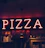 A warm, inviting corner of Savas Pizza with wooden booths and a glowing neon sign.