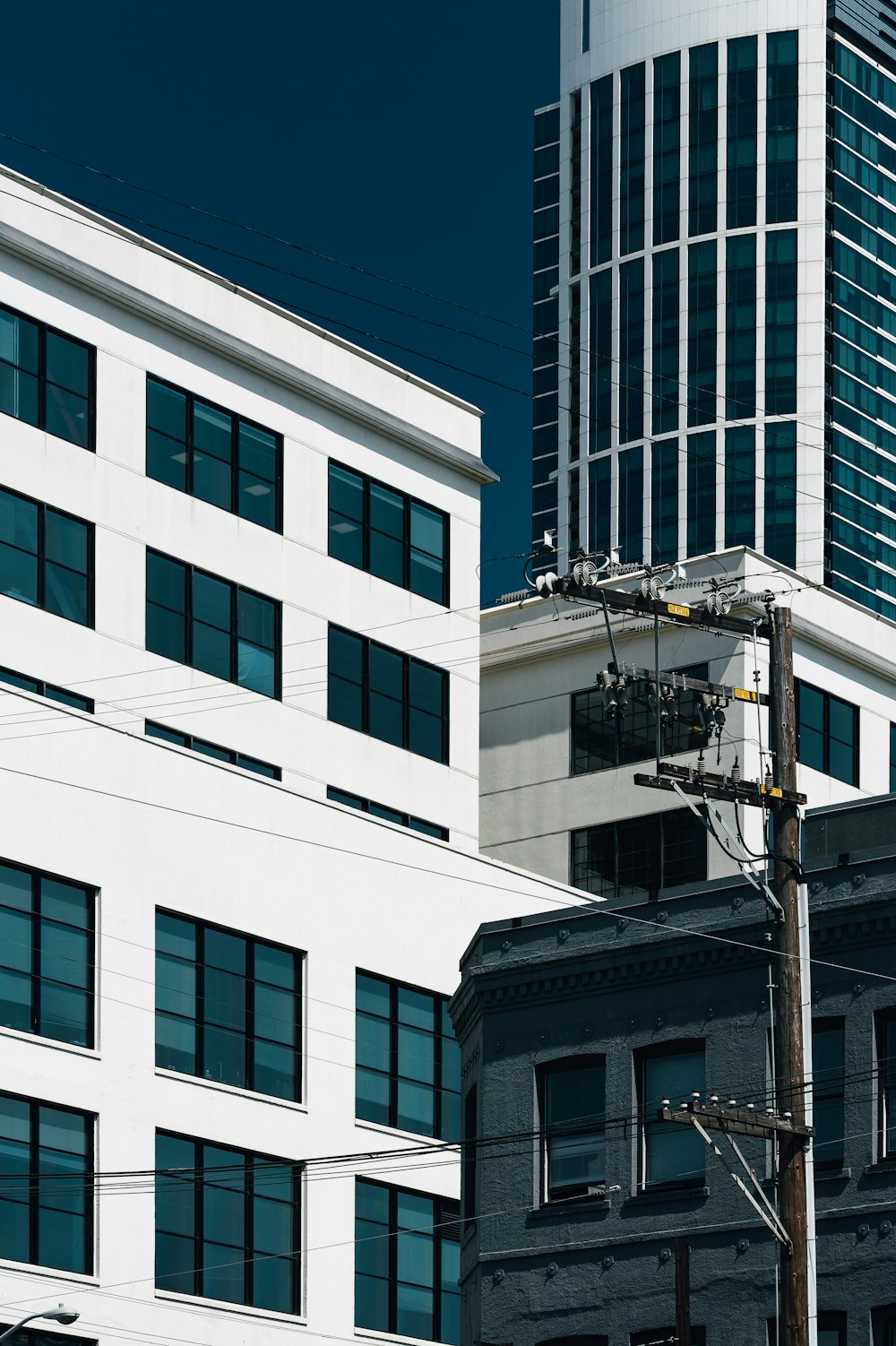 white and green building with glass windows at daytime