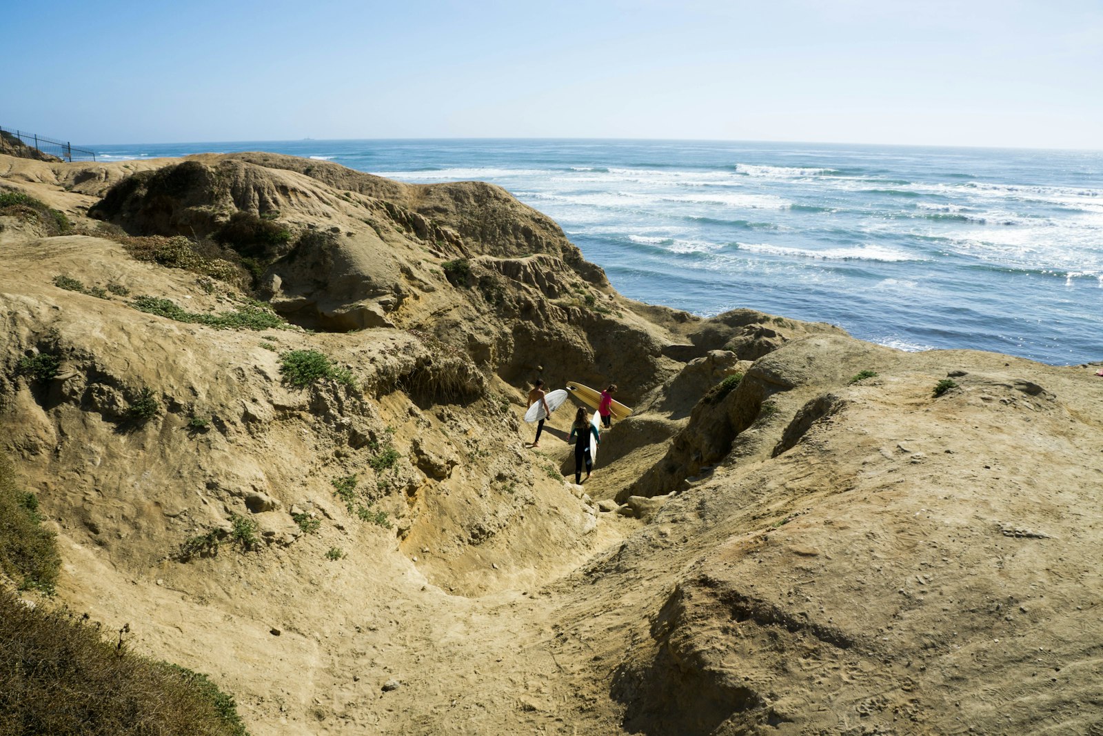 Sony a5100 + Sony E 18-55mm F3.5-5.6 OSS sample photo. Three persons carrying surfboards photography