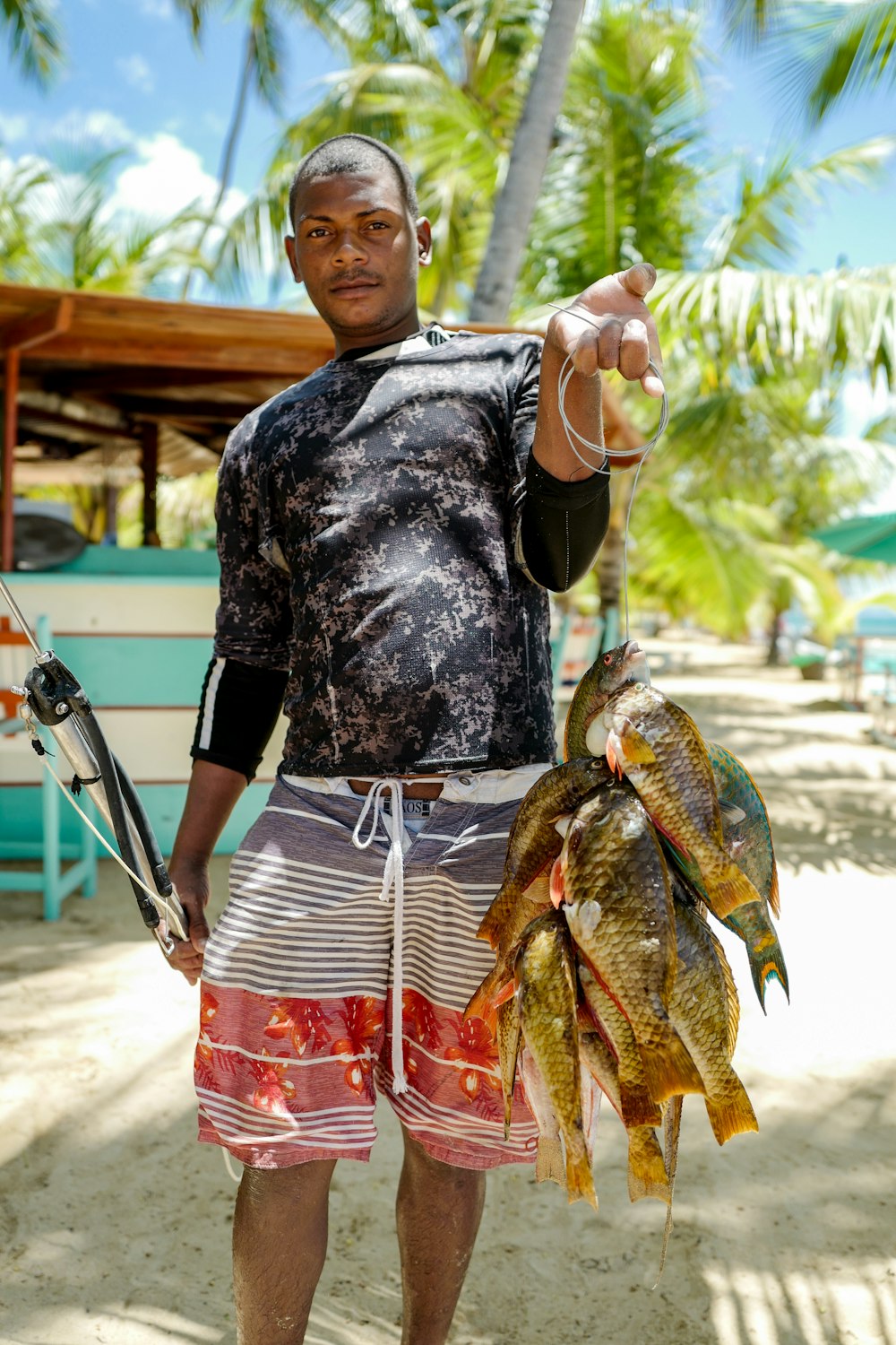 homem carregando peixes marrons