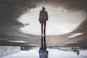 man's reflection on body of water photography
