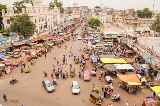 aerial photography of people and vehicles near mosque at daytime in Charminar India