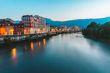 Elegant riverside resort reflecting soft golden light at dusk.