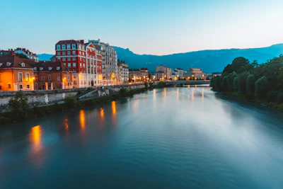 Elegant riverside resort reflecting soft golden light at dusk.