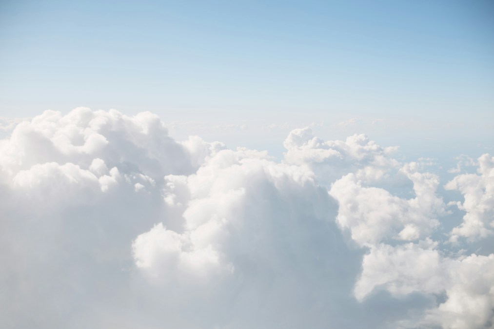 Wide open blue sky with white clouds over a sunny Texas landscape