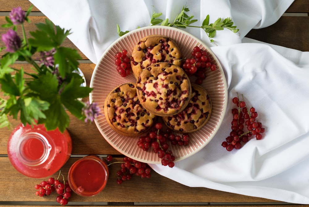 a plate of cookies and berries on a table