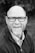 grayscale of man wearing eyeglasses