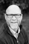 grayscale of man wearing eyeglasses