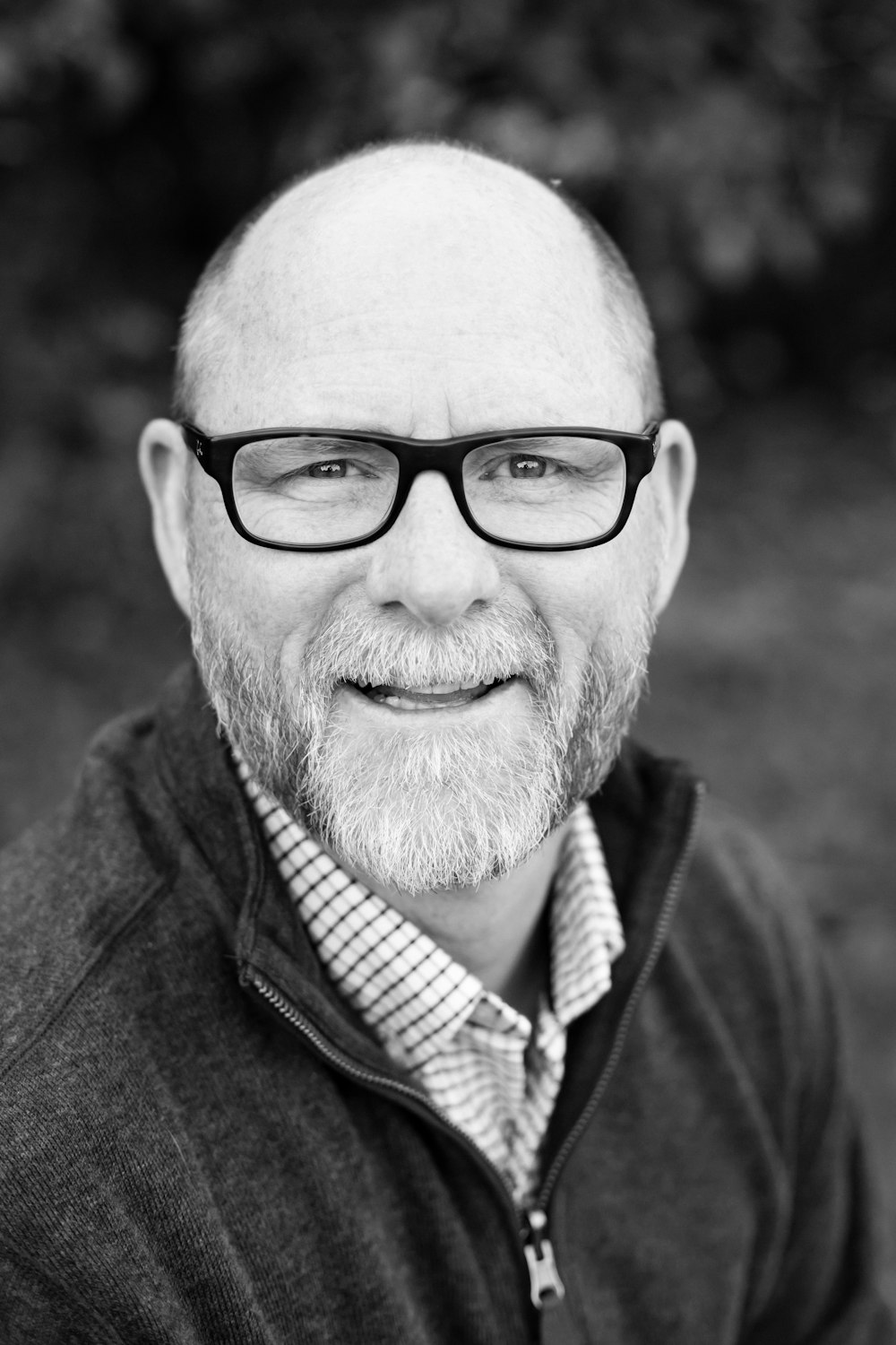 grayscale of man wearing eyeglasses