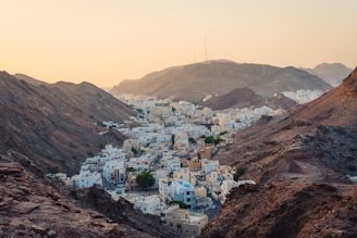 aerial view of white concrete buildings near rock cliffs