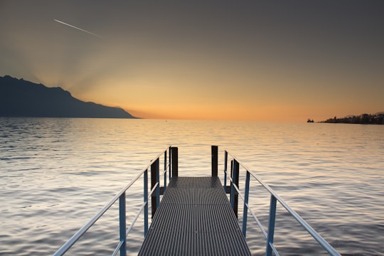 gray metal dock facing horizon in Montreux Switzerland