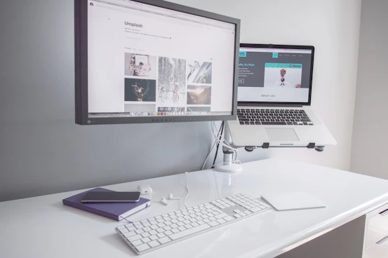 A sleek, minimalist workspace with a laptop displaying financial charts and a neat notepad beside it.