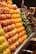 A colorful display of fresh fruits and vegetables at a market stall.