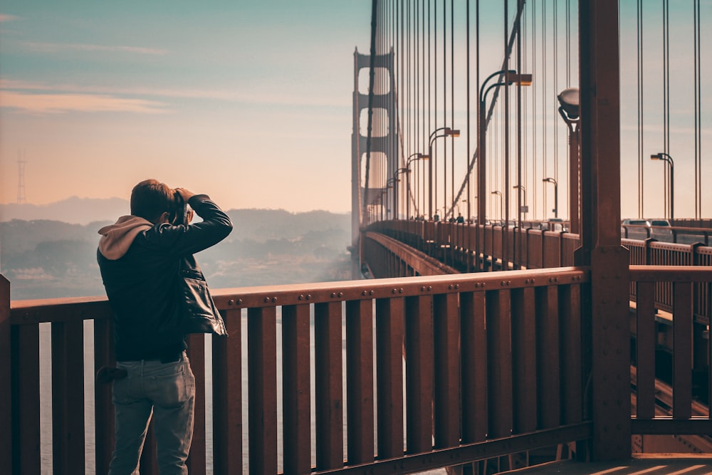 person standing on bridge taking picture