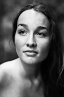 A serene black and white portrait capturing raw emotion in natural light.