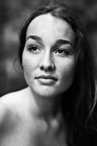 A serene black and white portrait capturing raw emotion in natural light.