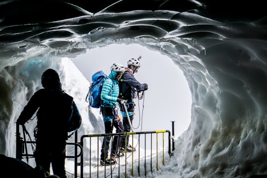people walking on ice covered cave in Aiguille du Midi France